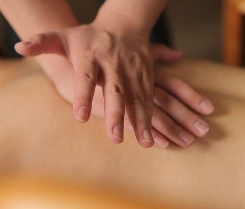 Two Hands Massaging A Back