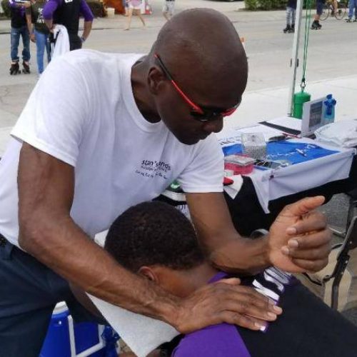 African American Male Receiving A Chair Massage